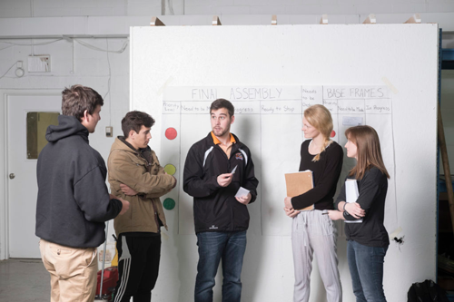 ISE students studying at a white board
